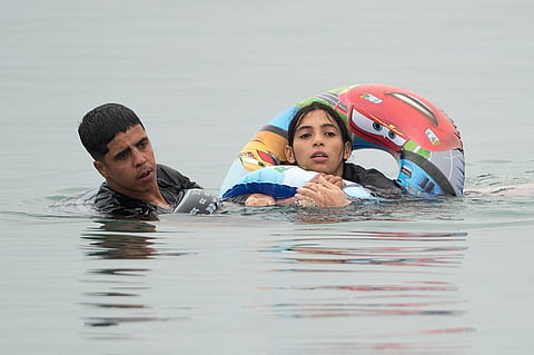 Migrants swim around a border barrier with Morocco to enter Spain's north Africa's Ceuta enclave on July 31, 2026.