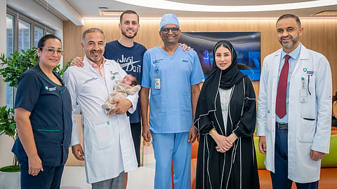 Consultant Paediatric Surgeon Dr Ahmad Alsweed, Consultant Neonatologists Dr Sridhar M. Ramaiah and Dr Osama Hamud, and the American Hospital Dubai team with the patient and his family
