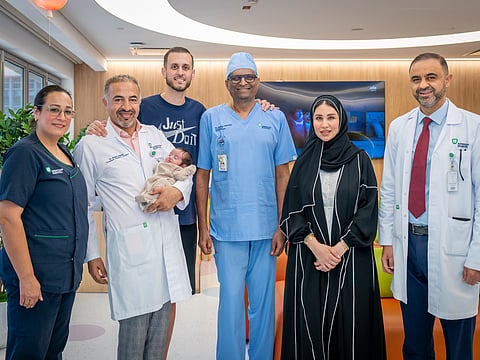 Consultant Paediatric Surgeon Dr Ahmad Alsweed, Consultant Neonatologists Dr Sridhar M. Ramaiah and Dr Osama Hamud, and the American Hospital Dubai team with the patient and his family
