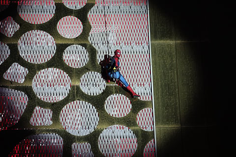 Marvel fans cheered as the superhero scaled the 150-metre landmark under the night sky.