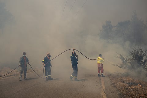 Volunteers and Greek firefighters work to extinguish a wildfire near Porto Germeno, some 70 kilometres  northwest of Athens in the region of Viotia, on August 2, 2026.