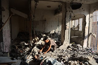 Palestinian residential salvage what they can from an apartment targeted in overnight Israeli airstrikes in Gaza City on August 2, 2026.