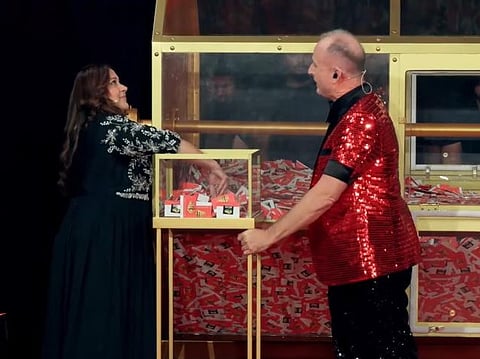 Last month's winner Kanika Arora chooses the winning ticket of this month as show host Richard assists her. 