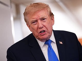 US President Donald Trump speaks to the press aboard Air Force One on August 2.