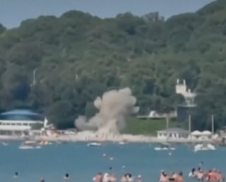 Smoke rises following a blast that killed six people, including three children, following a reported Ukrainian drone attack on a Russian resort village on the Black Sea. At least 40 others were wounded, the regional governor said Monday.