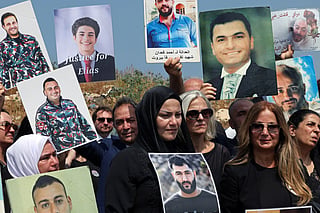 Family members carry the portraits of the victims of 2020 Beirut port blast as they gather near the blast's ground zero on the sixth anniversary of the explosion, in Beirut on August 4, 2026.