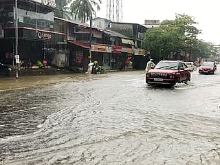 Vehicles make their way through a waterlogged street after rainfall, in Kozhikode on Sunday, August 2, 2026. 