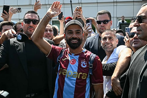 Egyptian forward Mohamed Salah gestures as he arrives at Istanbul Ataturk Airport to complete his transfer to Turkish football club Trabzonspor in Istanbul on August 5, 2026.