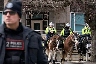 Toronto police officers on horseback stand watch outside the US Consulate in Toronto.
