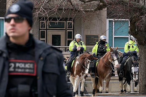 Toronto police officers on horseback stand watch outside the US Consulate in Toronto.