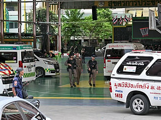 Armed police walk through the school premises after a shooting in Bang Kruai district, Nonthaburi province, north of Thailand's capital Bangkok, on August 7, 2026.