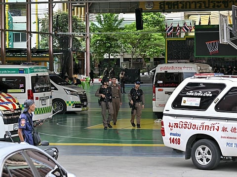 Armed police walk through the school premises after a shooting in Bang Kruai district, Nonthaburi province, north of Thailand's capital Bangkok, on August 7, 2026.