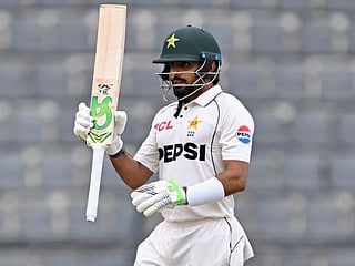 Pakistan’s Babar Azam celebrates after scoring a half-century (50 runs) during the second day of the second Test cricket match between Bangladesh and Pakistan at the Sylhet International Cricket Stadium in Sylhet on May 17, 2026.