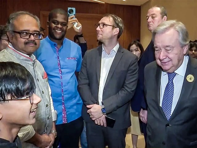 UN Secretary-General Antonio Guterres interacts with AI prodigy Raul John Aju on the sidelines of the AI Impact Summit, in New Delhi in Feb 2026.