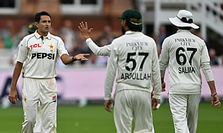 Pakistan's Muhammad Abbas (L) celebrates with teammates after taking the wicket of England's Jofra Archer (unseen) for 14 runs on day one of the second test match between England and Pakistan at Lord's cricket ground in London on August 27, 2026.
