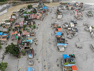 This aerial photograph shows houses covered heavily in sludge in the aftermath of flash floods at Devighat in Nepal's Nuwakot district on August 29, 2026. 