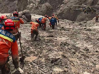 In this photo released by Xinhua News Agency, rescuers carry out search and rescue operations at the mudslide-hit Gyirong Port in Gyirong County, southwestern China's Tibet Autonomous Region on Saturday, Aug. 29, 2026. (Lhasa fire and rescue mobile detachment//Xinhua via AP)