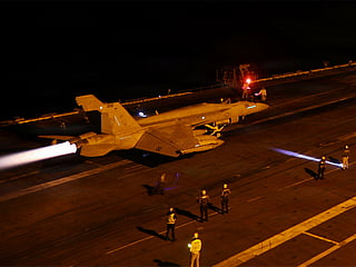 US sailors conduct night flight operations aboard USS George Washington (CVN 73) as the ship sails in regional waters supporting operations in the Middle East. 