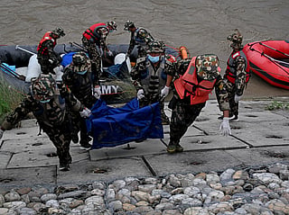 Nepal's army personnel carry the bodies of deceased flood victims during a search operation along the Narayani river at Bharatpur in Nepal's Chitwan district on August 31, 2026.