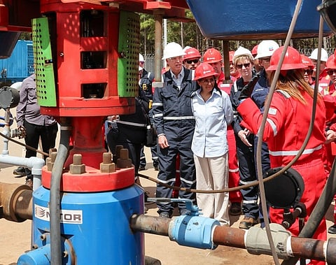 This handout picture released by the Venezuelan Presidency shows Venezuela's Interim President Delcy Rodriguez (C), US Secretary of Energy Chris Wright (L), US diplomatic mission to Venezuela, Laura Farnsworth Dogu (R), and workers from the state oil company Petroleos de Venezuela (PDVSA) during a visit to the Orinoco oil belt in southern Venezuela on February 12, 2026.