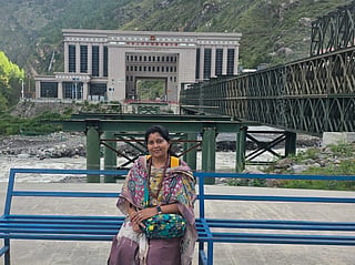 Mohana Sowjanya in front of the immigration building that was swept away during the flash floods 