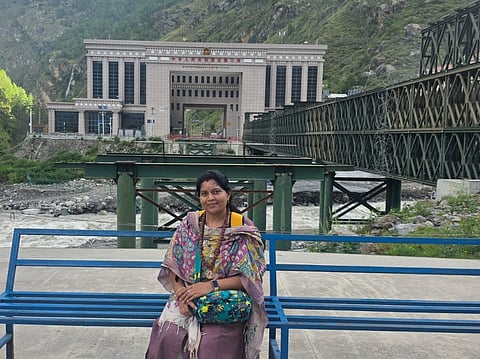 Mohana Sowjanya in front of the immigration building that was swept away during the flash floods 