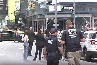 This image made from video provided by WABC shows NYPD officers on the scene after a woman brandishing two large knives was shot by officers in Times Square in New York, Monday, Aug. 31, 2026. 
