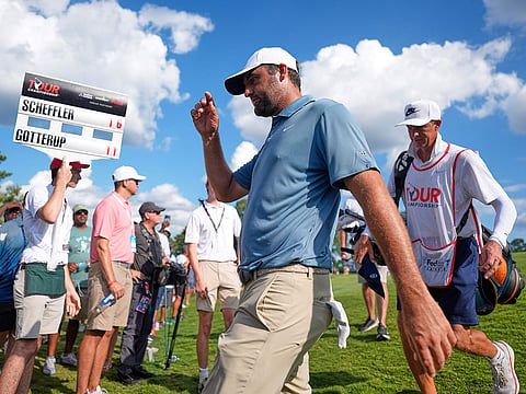 Scottie Scheffler walks off the 17th green during the PGA Tour Championship golf tournament.
