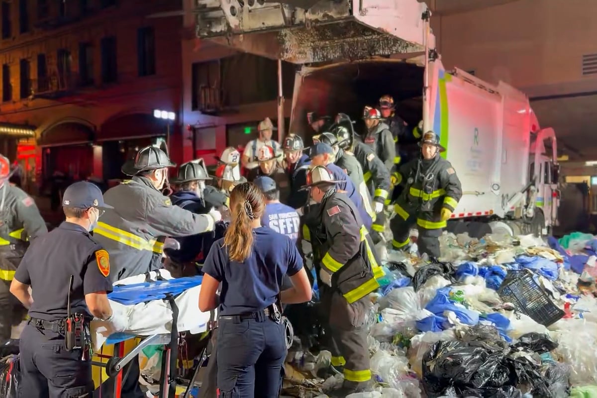 A passer-by heard cries for help after the truck had already compacted its first load.