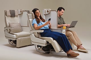 This image shows customers enjoying the enhanced privacy offered by Emirates’ new Premium Economy seat. The full-height adjustable privacy screen between every seat can be raised or lowered at the touch of a button, allowing customers to create their own personal space for relaxing, working or dining.