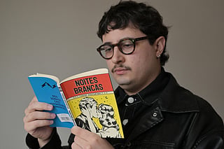 Brazilian book influencer Marcelo Nogueira, reads a pocket book version of "White Nights" of Russian writer Fyodor Dostoevsky, in Sao Paulo, Brazil on August 25, 2026.