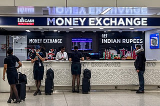 People exchange currencies at the money exchange counter at the Indira Gandhi International Airport in New Delhi on September 5, 2026.