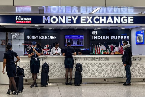 People exchange currencies at the money exchange counter at the Indira Gandhi International Airport in New Delhi on September 5, 2026.