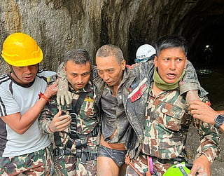 In this photo provided by the Nepal Army, a Chinese national is seen after being rescued by soldiers during an ongoing operation at the Trishuli-3A hydropower project in Nepal's Rasuwa district, Saturday, Sept. 5, 2026. 