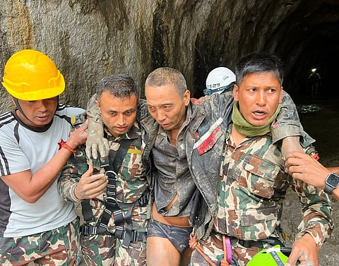 In this photo provided by the Nepal Army, a Chinese national is seen after being rescued by soldiers during an ongoing operation at the Trishuli-3A hydropower project in Nepal's Rasuwa district, Saturday, Sept. 5, 2026. 