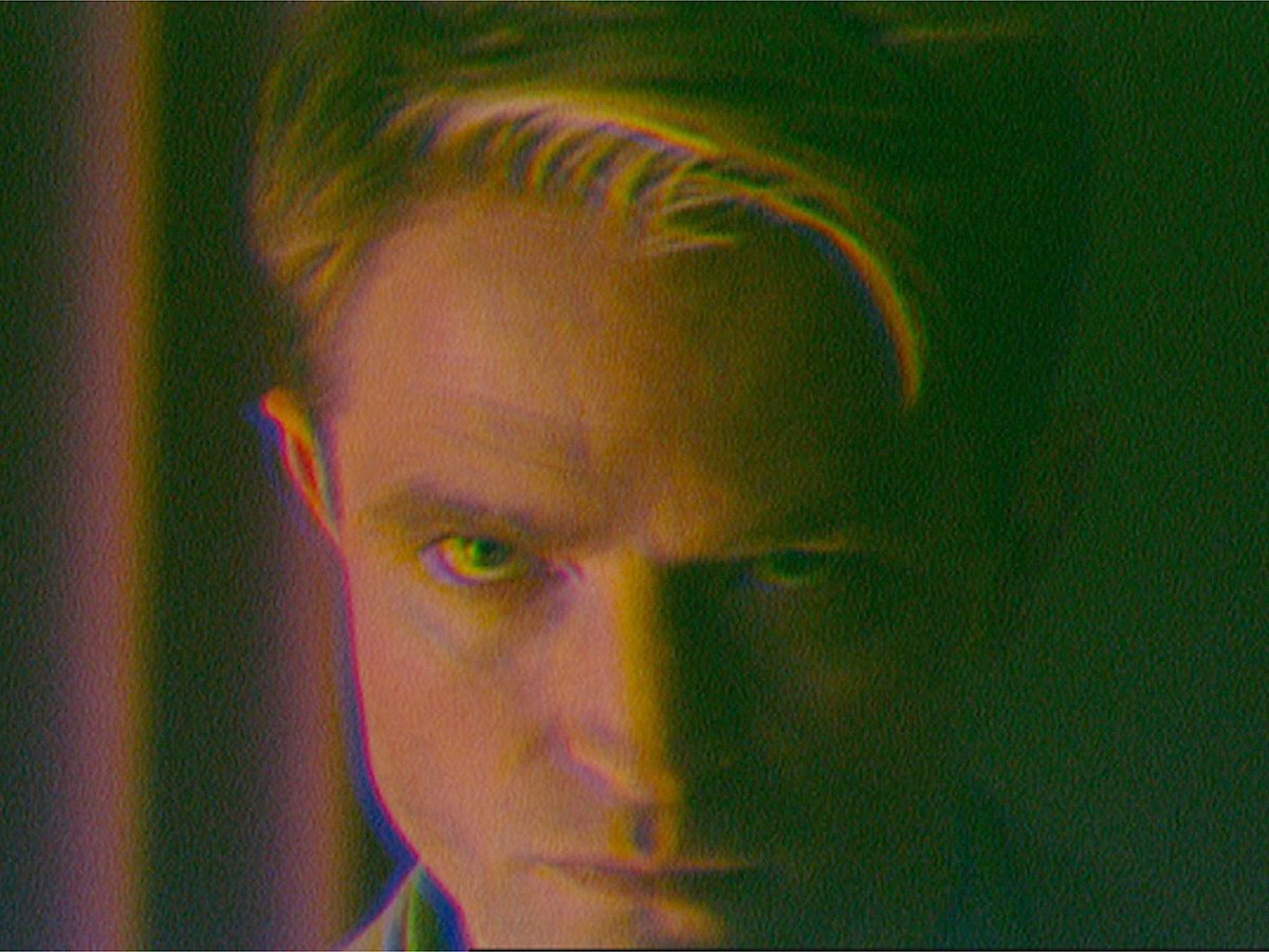 This image released by A24 shows Robert Pattinson, left, in a scene from the film "Primetime." 