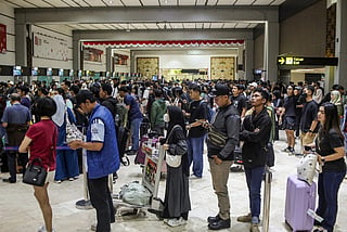 Stranded passengers line up to request refunds after scheduled flights were canceled following the eruption of Mount Anak Krakatoa at Soekarno-Hatta airport in Tangerang on September 6, 2026.
