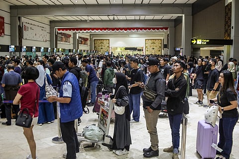 Stranded passengers line up to request refunds after scheduled flights were canceled following the eruption of Mount Anak Krakatoa at Soekarno-Hatta airport in Tangerang on September 6, 2026.