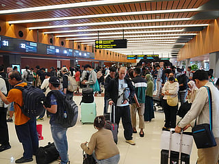 Travelers queue up for check in at Soekarno-Hatta International Airport in Tangerang, Indonesia.