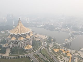An aerial view shows haze shrouding the area around the Sarawak Legislative Assembly building (L) in Kuching, the capital city of Sarawak state on the island of Borneo.