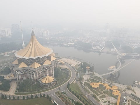 An aerial view shows haze shrouding the area around the Sarawak Legislative Assembly building (L) in Kuching, the capital city of Sarawak state on the island of Borneo.