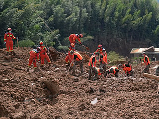 Rescuers search for survivors in a mudslide-hit area of Mingkeng village in Suichuan, in China's eastern province of Jiangxi, Sunday, Sept. 6, 2026. 