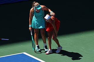 Mirra Andreeva, of Russia, left, helps Anastasia Potapova, of Austria, after Potapova fell during the fourth round of the U.S. Open tennis championships, Monday, Sept. 7, 2026, in New York. (AP Photo/Andres Kudacki)