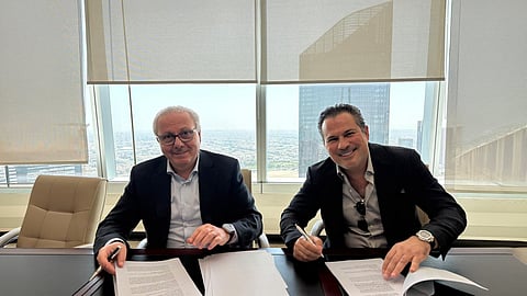 Nagib Bahous (left) and Ibrahim Arqawi during the signing ceremony.