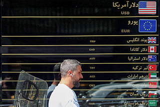 A man walks past a currency exchange along a street in Tehran on September 7, 2026.