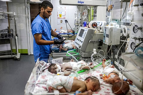A medical worker checks on prematurely-born babies lying in infant warmer beds at the overcrowed neonatal intensive care unit (NICU) at Nasser Medical Complex in Khan Yunis in the southern Gaza Strip on September 7, 2026.