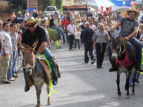 Competitors ride donkeys during an annual race held in the southern village of Roum, Lebanon.