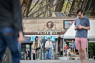 Pedestrians walk past an entrance of Eiffel Tower in Paris on September 8, 2026. The Eiffel Tower reopened on September 8.