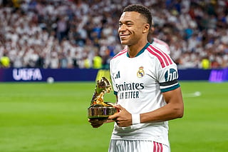 Real Madrid's French forward #10 Kylian Mbappe receives the trophy for most goals in the UEFA Champions League season 2025-2026 before the UEFA Champions League first round day 1 football match between Real Madrid and Inter Milan at the Santiago Bernabeu stadium in Madrid on September 8, 2026.