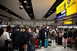 Delayed passengers wait and queue with their luggage at Terminal 3 of London Heathrow airport, west of London on September 8, 2026, following major disruption due an issue affecting the NATS air traffic control systems.